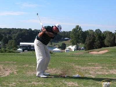 Golfer demonstrating low hands, high clubhead with a short iron. - Keiser Golf