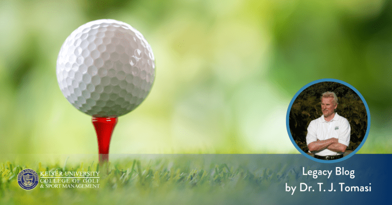 Golf ball on a red tee with blurred green background, featuring Dr. T.J. Tomasi from Keiser University College of Golf.