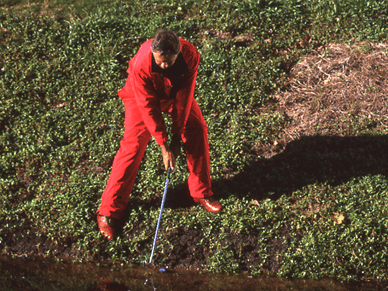 man playing golf in red attire 