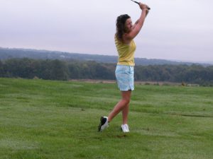 Woman Golfer Swinging Her Club