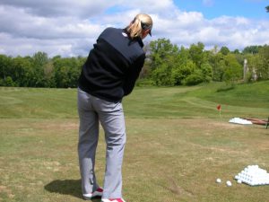 Woman Golfer Practicing Her Swing