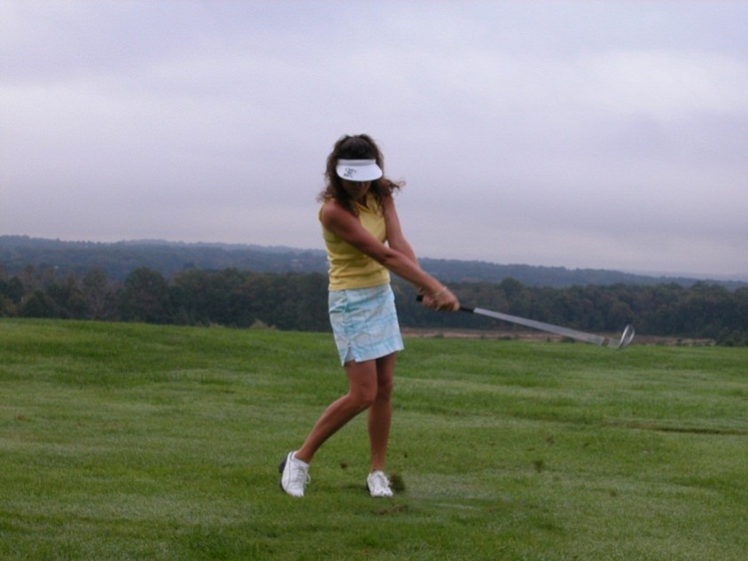 Woman Golfer Hitting Ball