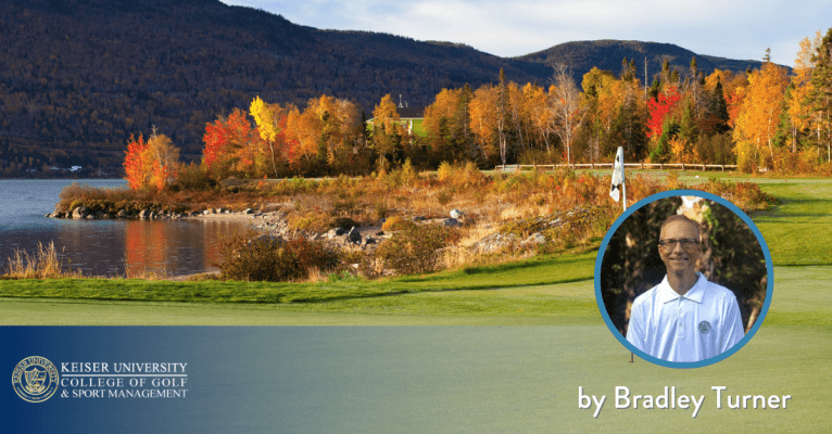 Golf green by a lake with fall foliage and mountains, featuring Bradley Turner from Keiser University College of Golf.