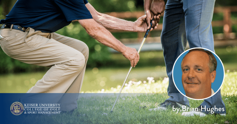 Golf coach adjusting a student’s grip during a lesson, with a Keiser University College of Golf logo and a portrait of PGA Master Professional Brian Hughes.