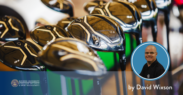 Modern golf club drivers lined up in a retail display at Keiser University College of Golf.